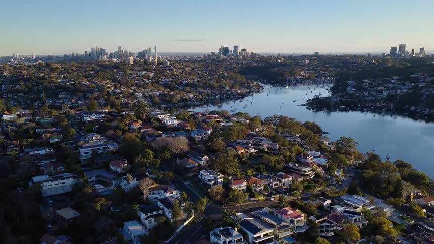 A residential neighborhood bordered by a canal and buildings surrounded by trees and green vegetation