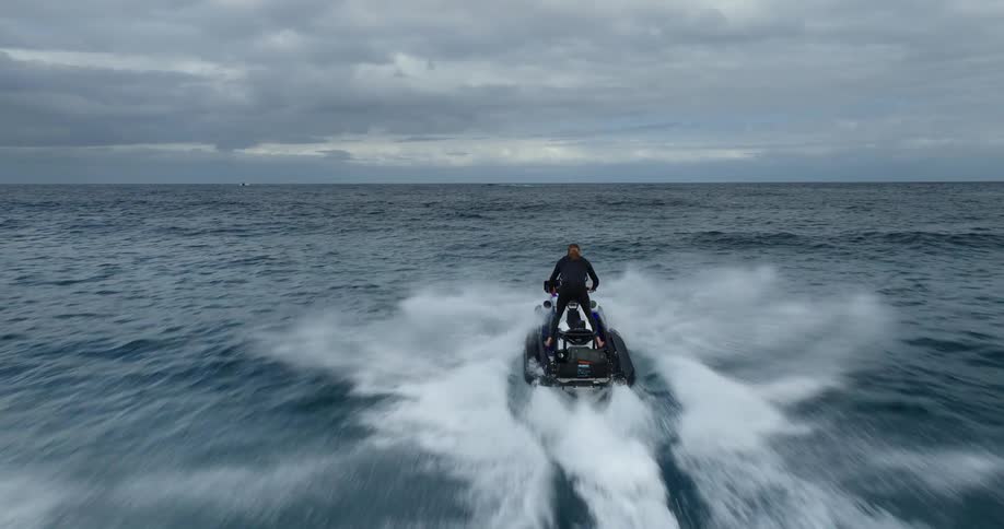 Man speeding in an ocean with jet ski