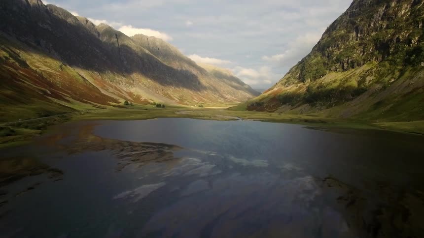 The lake water is still in this valley