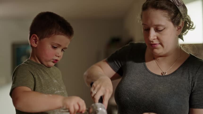 Mother and son cooking together in the kitchen