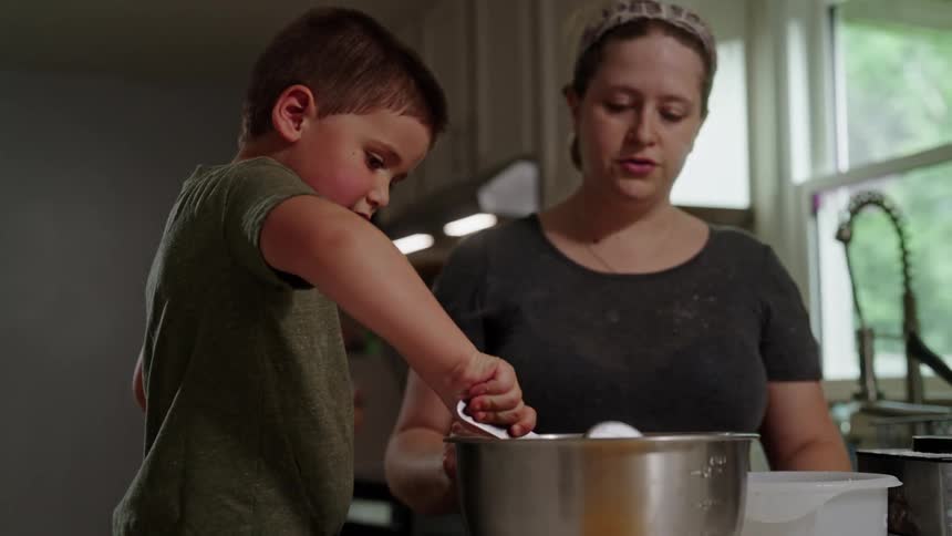 Mother and son baking together in the kitchen