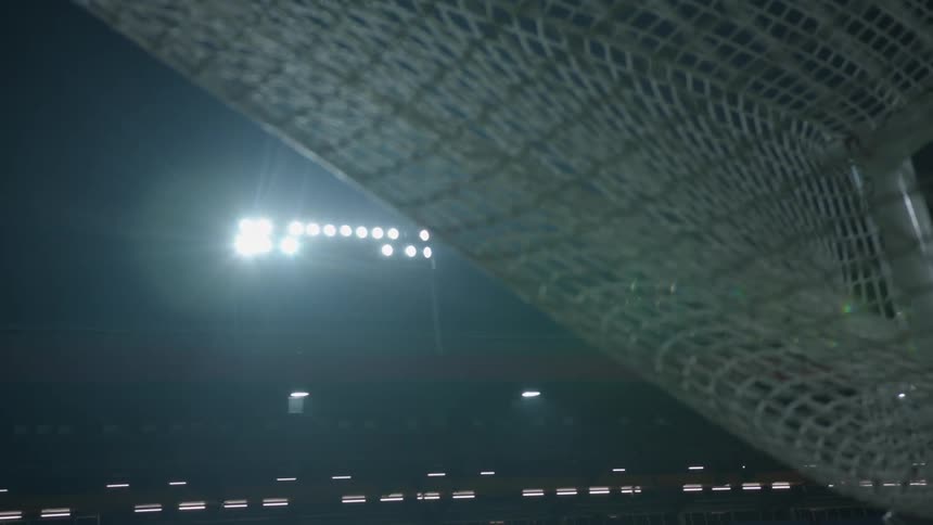 Stadium lights turn on and illuminate the stadium