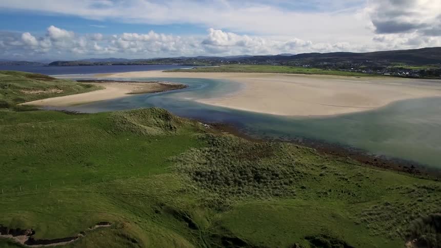 Over these green hills is a body of water