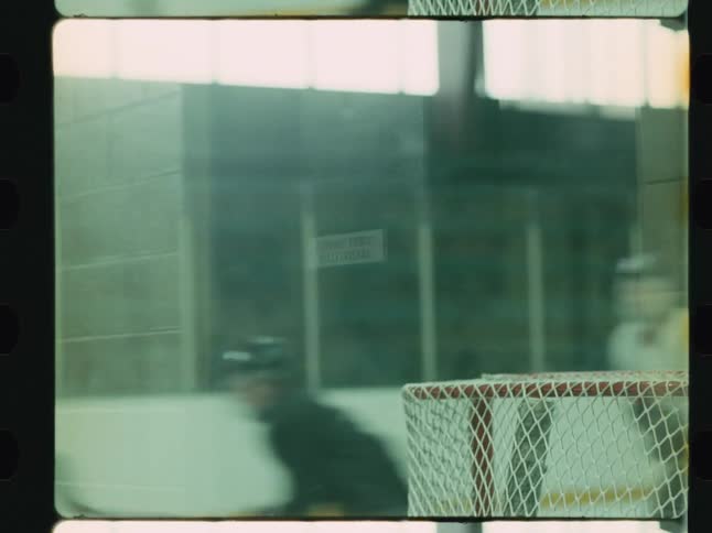 A filmstripstyle clip shows players passing around a hockey goal with a white net sitting on an ice rink