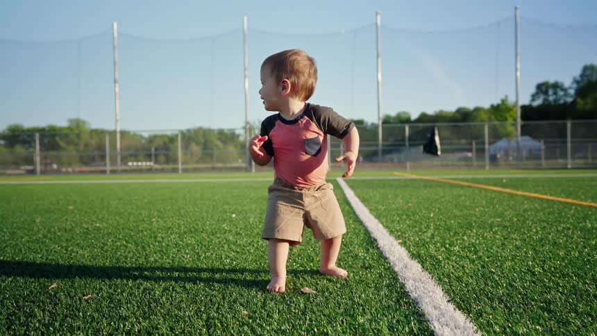 Little boy playing on a synthetic lawn