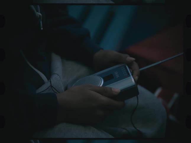 Person holding an old radio