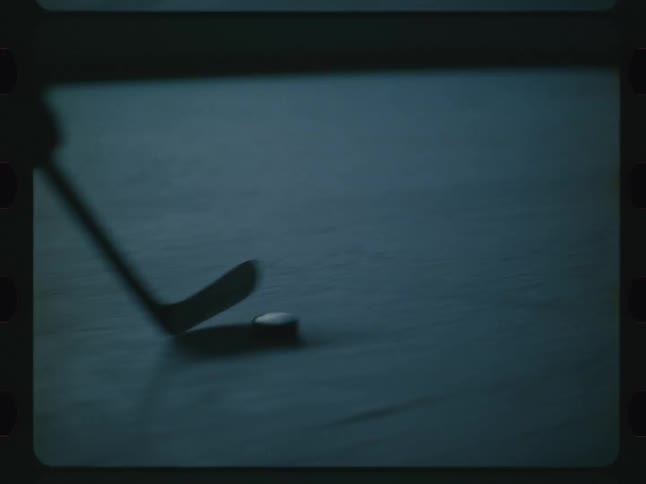 Ice hockey player handling the puck with the stick