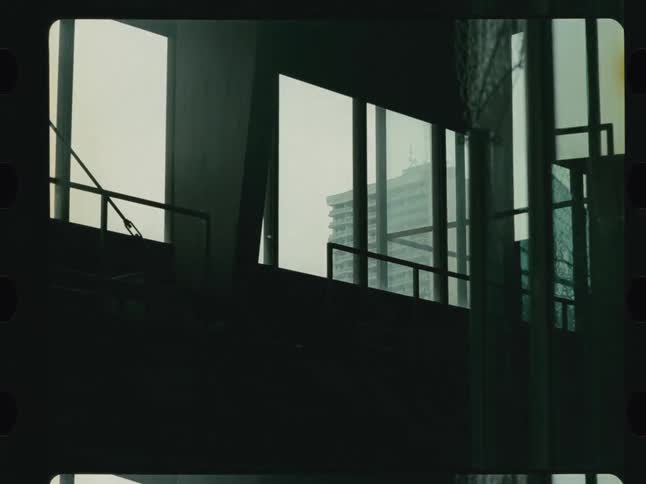 Light enters a dark building through large windows