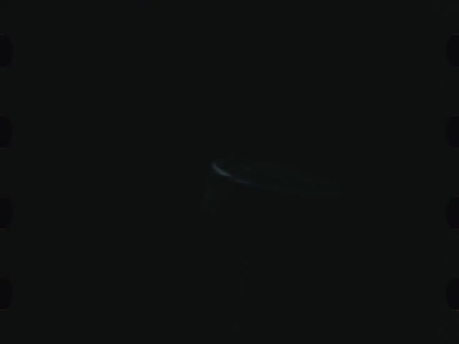 Abstract screw in rotating motion against a dark background
