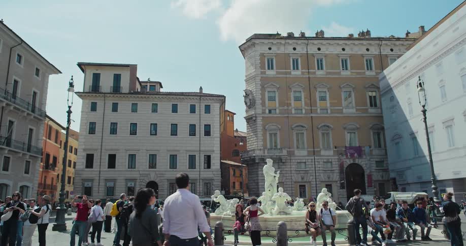 Crowd of people in a square of a classical city