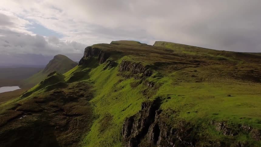 Green grass and moss grows on the hillside