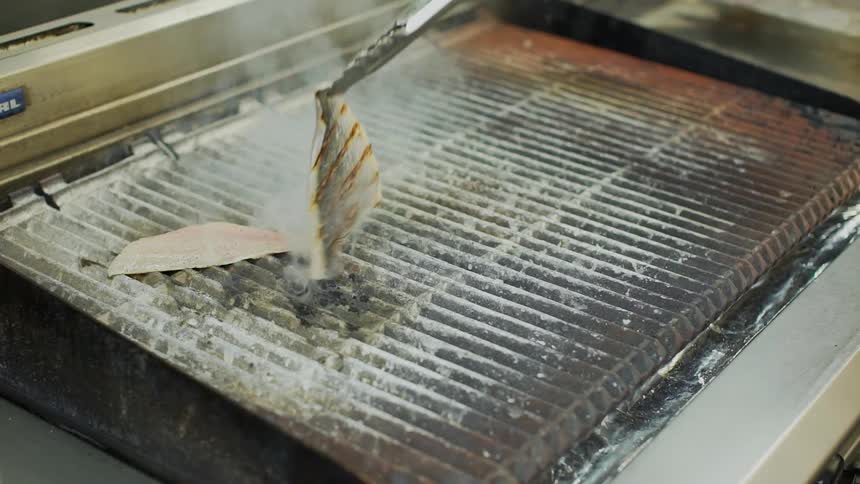 Food is cooking on a barbecue