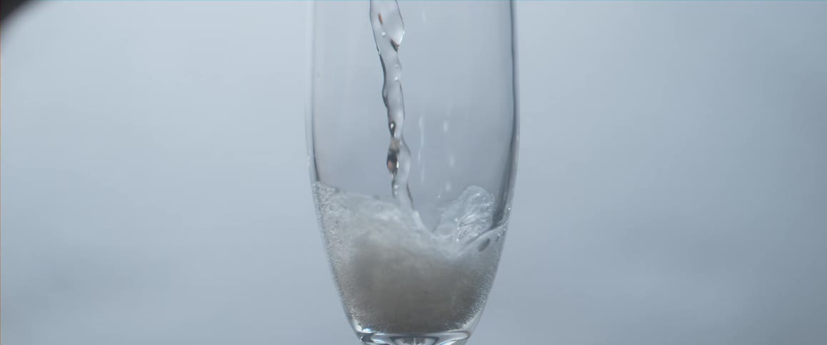 Water pouring slowly into a glass