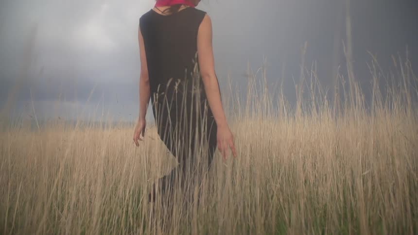 Woman walking through a grassy field