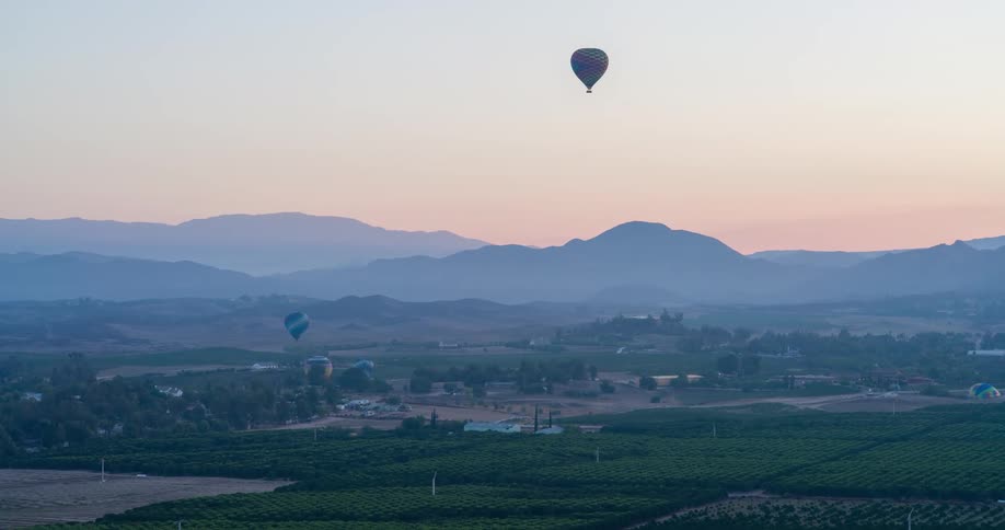 Mountain landscape with two flying balloons