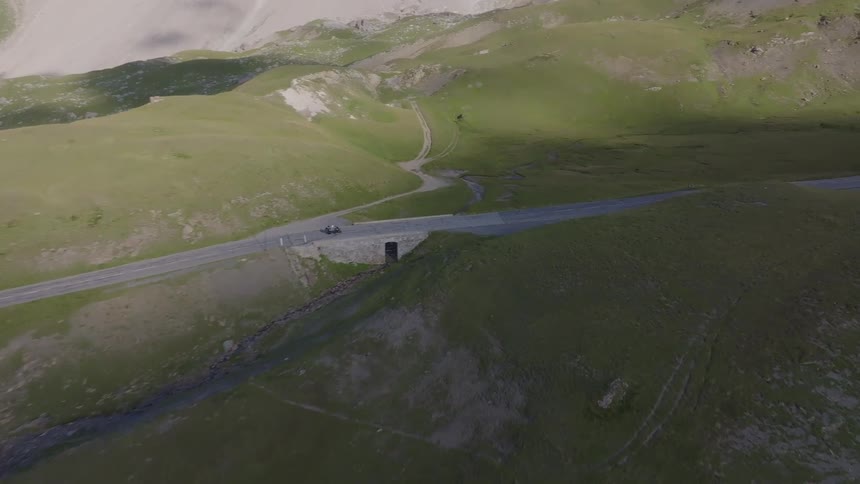 The vehicle speeds down the dirt trail