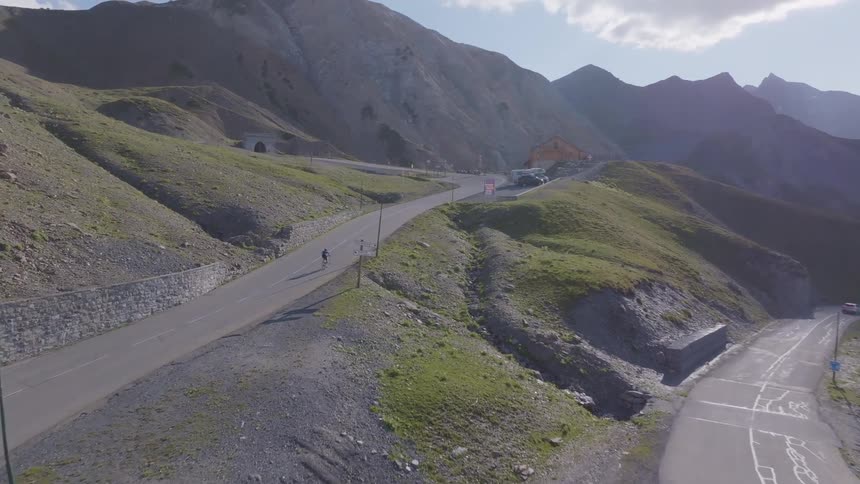 Cars and bicycles ride on the hills