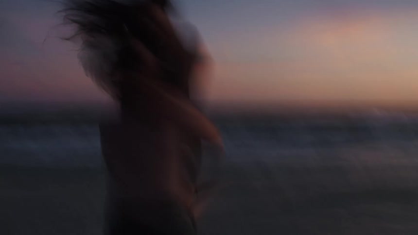 Silhouette of a couple embracing on the beach in the late afternoon