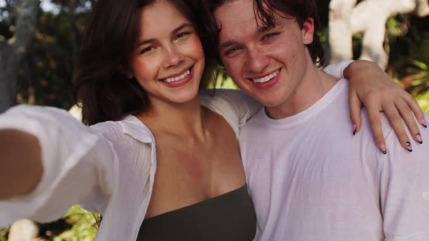 Smiling couple posing for a selfie outdoors