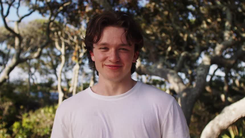 A teen smiling at the camera