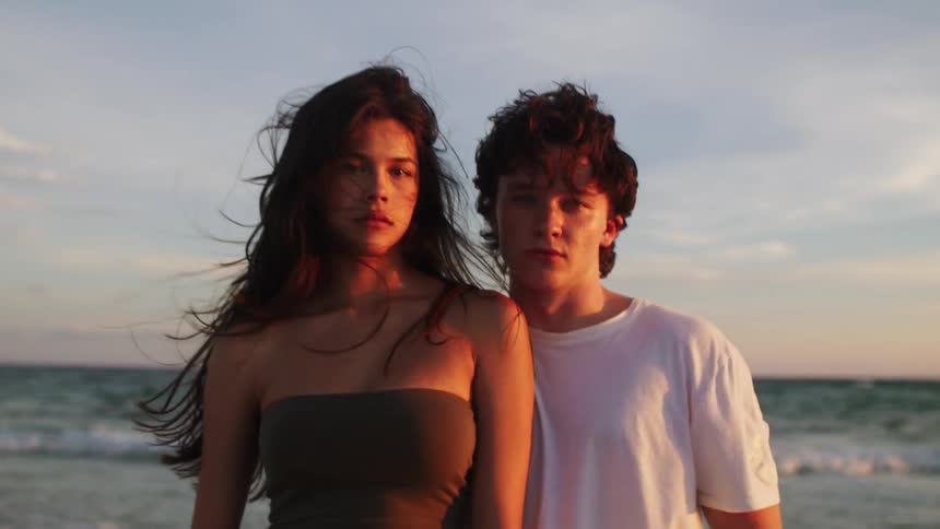Couple hugging on the beach in the late afternoon