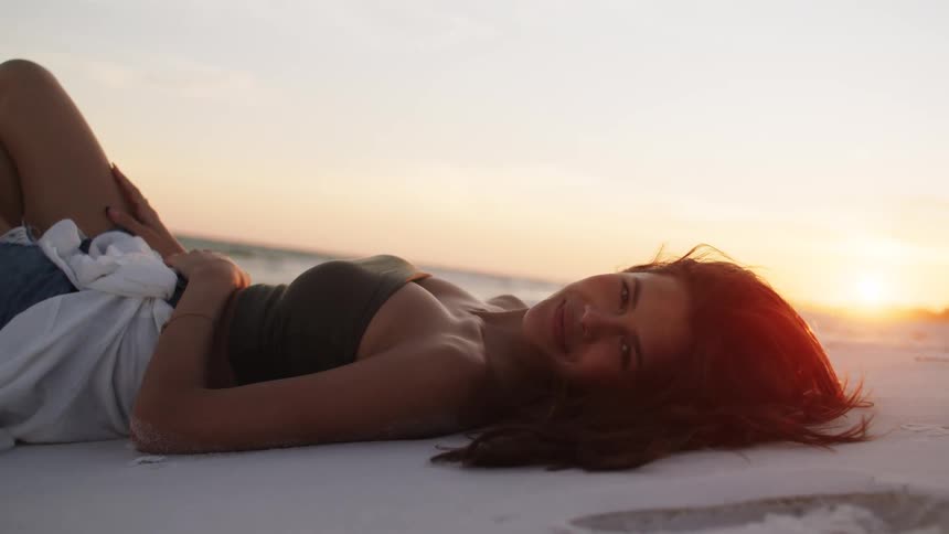 A woman lays on the beach
