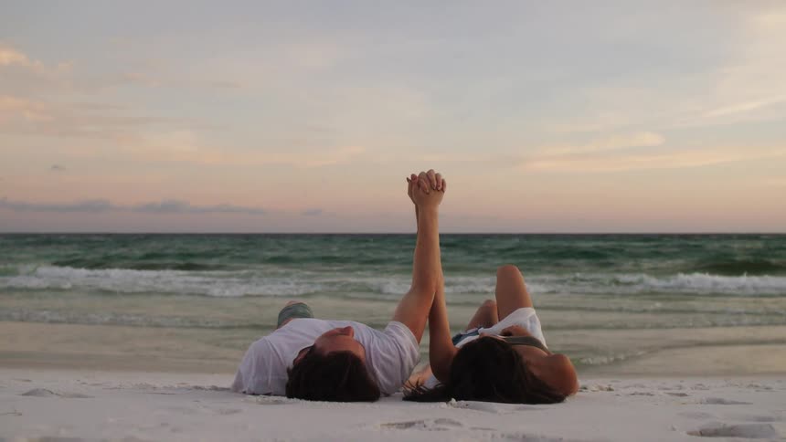 A couple laying on the beach