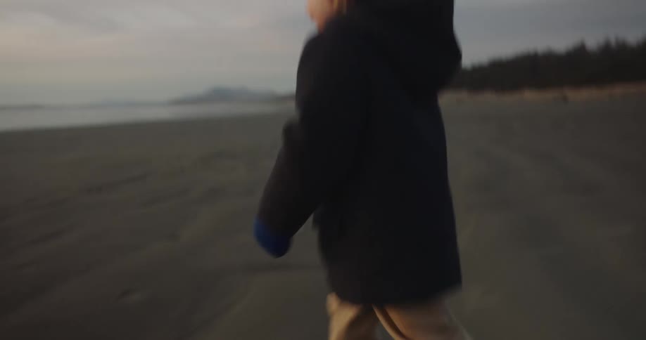 A boy is running on the beach