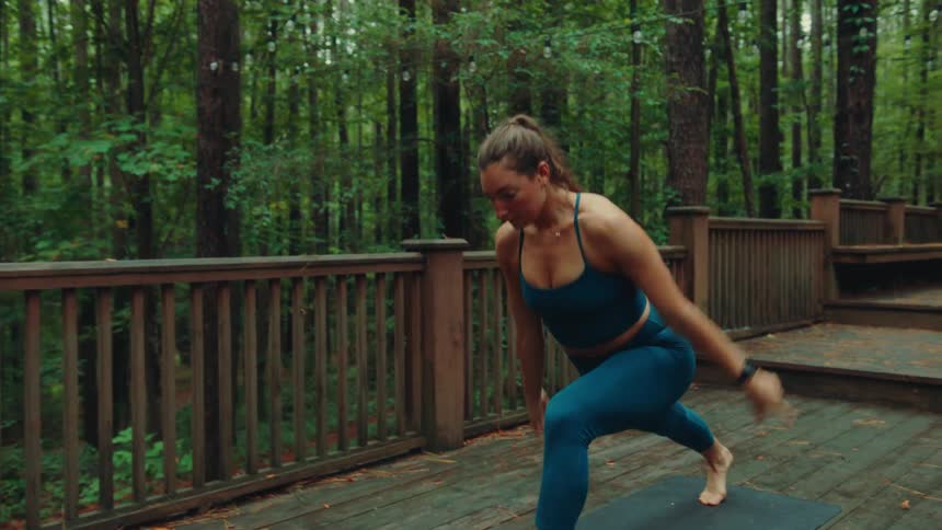 Woman doing yoga in an outdoor video in the forest