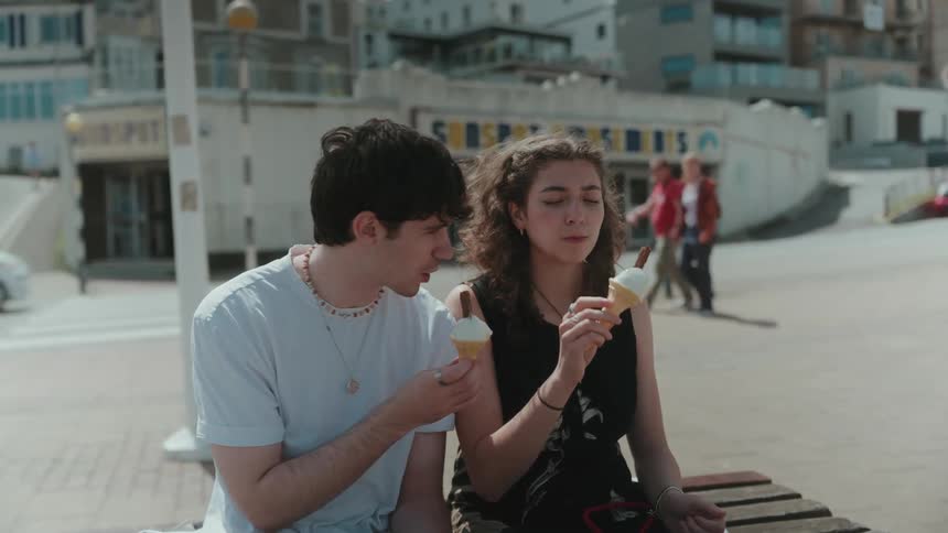 Two people sitting outdoors enjoying ice cream together