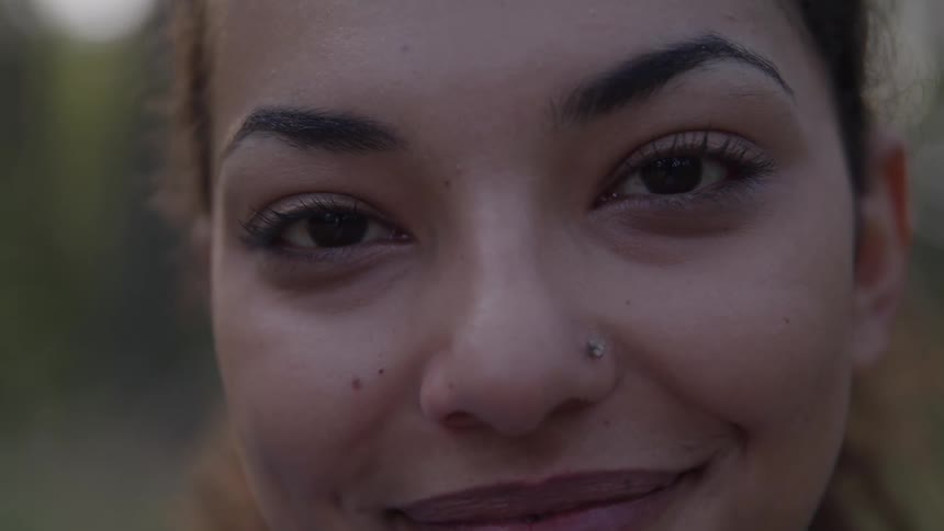 Closeup of a smiling woman with a nose piercing