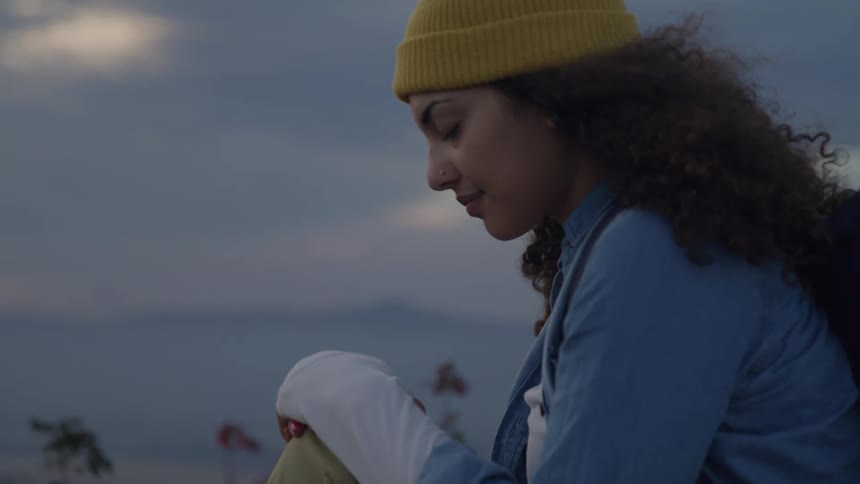 A girl sits with her eyes closed