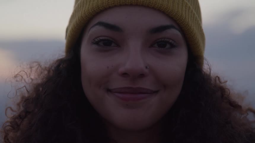 A woman smiles at the camera