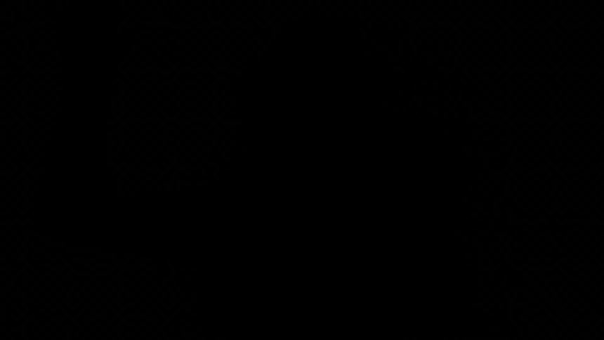 A persons shadow is pressed against glass in a dark room with flickering light