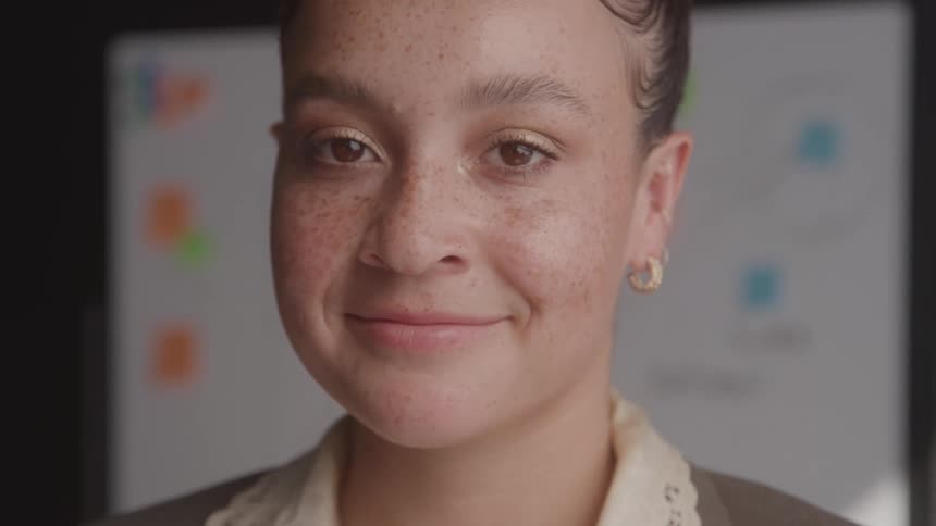 A woman smiles at the camera
