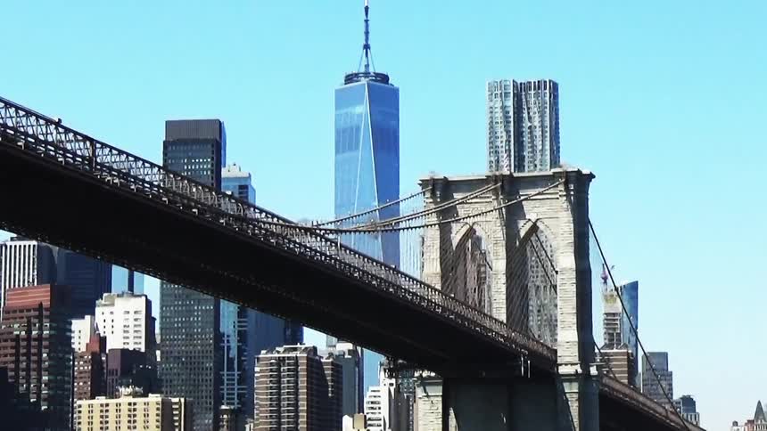 Towering skyscrapers and One World Trade Center lie beyond the Brooklyn Bridge