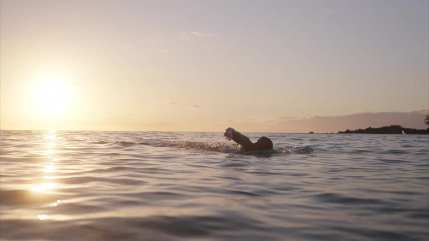 A man swims in the ocean