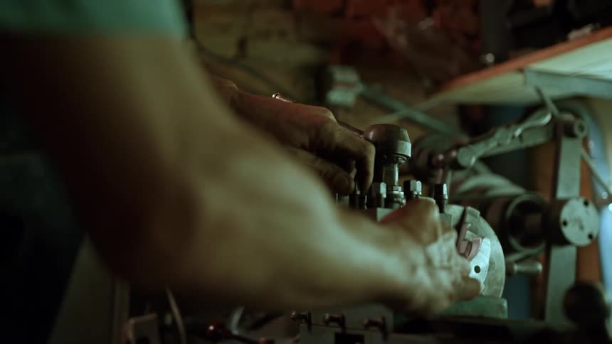 Man operates industrial machine in workshop