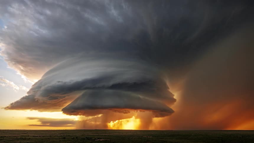 Landscape of a field with a tornado in action