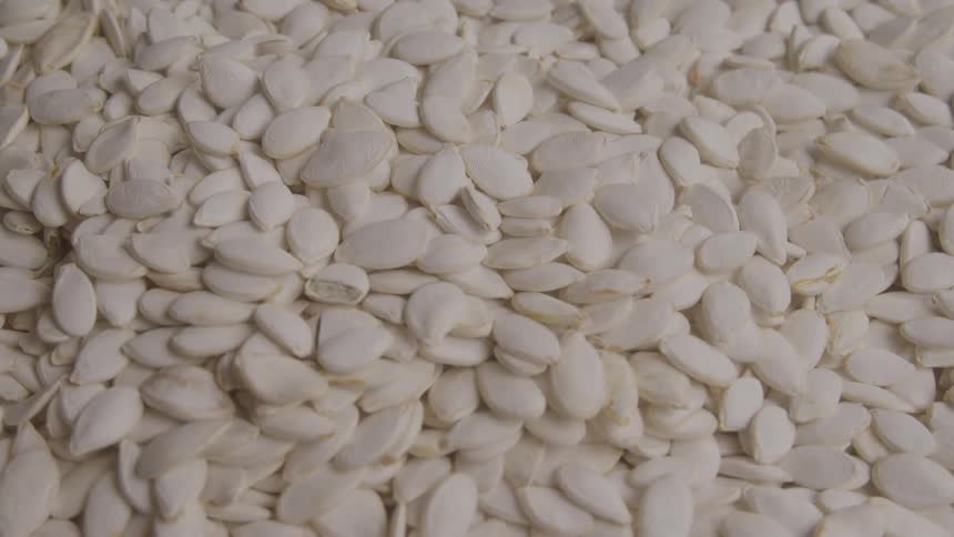 Shelled pumpkin seeds arranged in large quantity