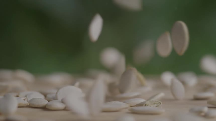 Seeds falling onto a wooden surface