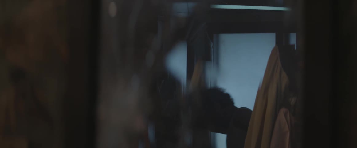 A broken mirror reflects a man beating a woman