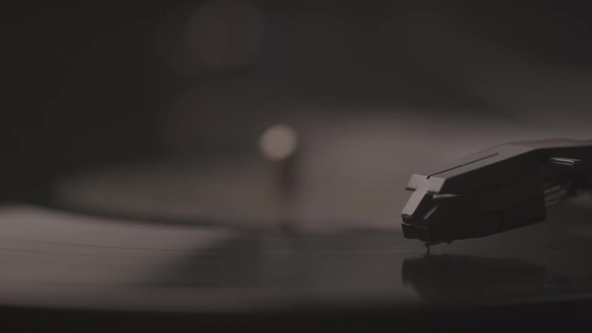 Turntable needle in contact with a vinyl record