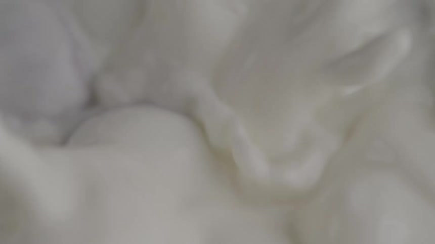 Nuts plunging into white cream