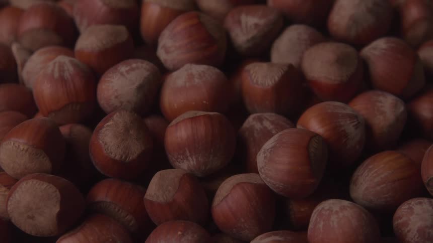 A closeup view of a pile of hazelnuts