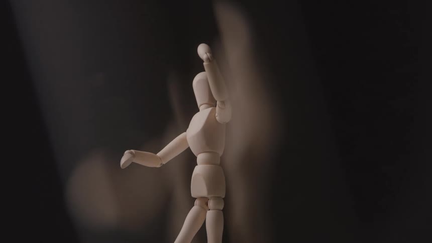 A figurine of a person is made of wood