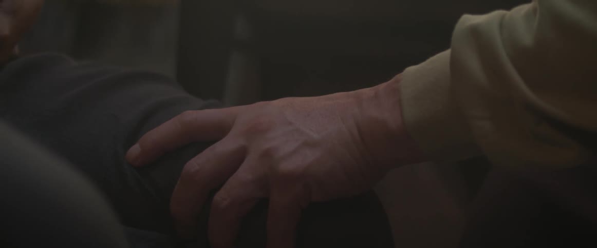 A man grabs the arm of another person