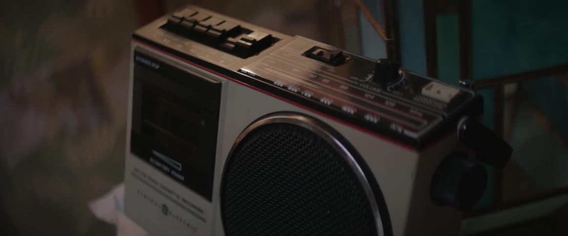 A boombox sits atop a side table