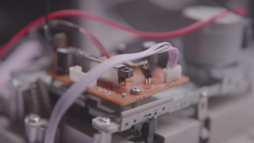 A circuit board with various electronic components and wires connected to it