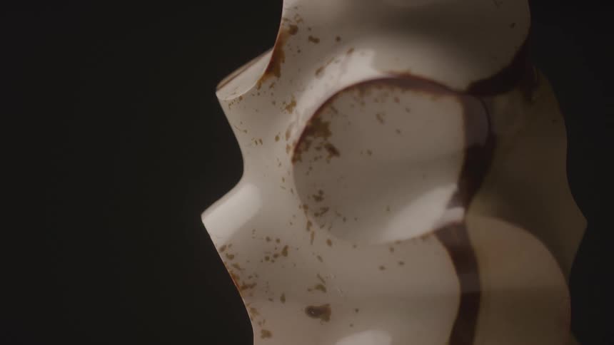 Closeup of an abstract lighttoned sculpture with dark spots